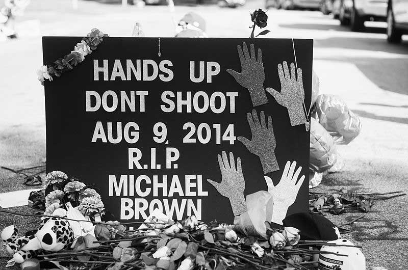 How do the hostile actions between police and black affect the society?