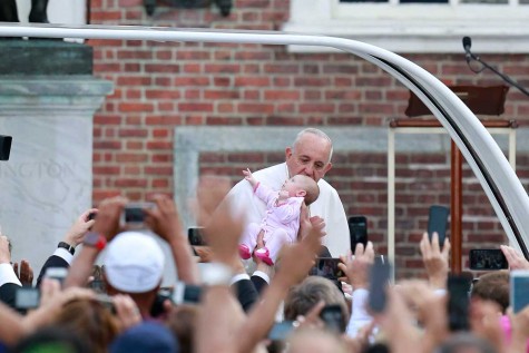 Pope Francis kisses a baby at Independence Hall in Philadelphia on Saturday, Sept. 26, 2015. (David Swanson/Philadelphia Inquirer/TNS)