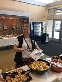 Señora Rodriguez serves some fruit.