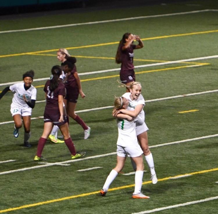 Teammates Katie Watt and Payton Neal congratulating junior, Katie Newman, on scoring her first goal of the season while taking on Holy Names in the semi-finals.