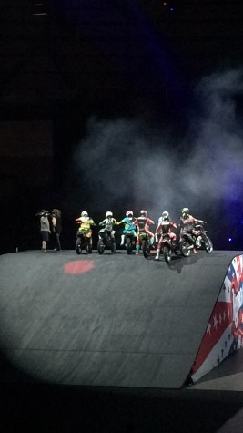 Several motorcyclists strike a pose at the top of a ramp. These riders were announced winners of the "coolest trick competition" that took place during the show. 