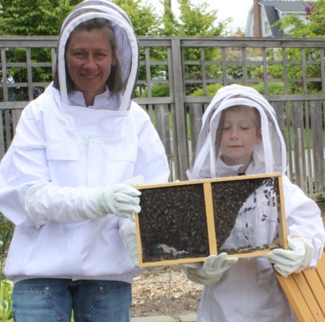Ms. Armstrong and son, Drew, receiving bees on delivery day from Southern California.