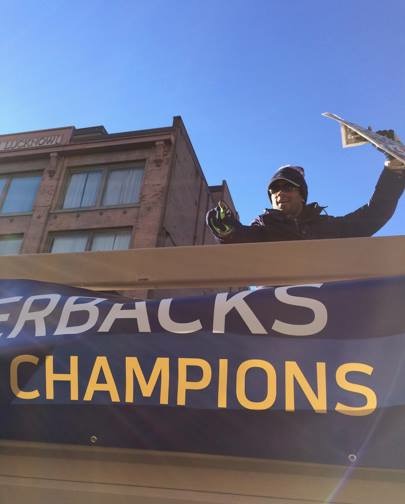 Seahawks quarterback, Russell Wilson, on the Seahawks parade float, in downtown Seattle, after winning Super Bowl 48 in 2014. Hes ready for another win no doubt!
