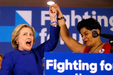A spirited Democratic presidential candidate Hillary Clinton, left, joins Geneva Reed-Veal, the mother of Sandra Bland, during a campaign rally at the Parkway Ballroom on Chicago's South Side on Wednesday, Feb. 17, 2016.