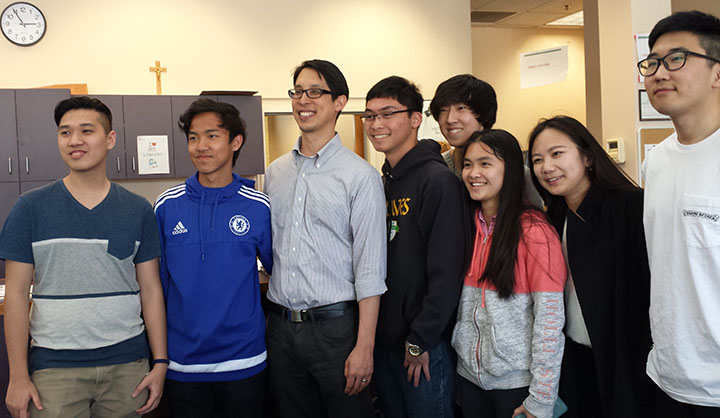 Author Gene Luen Yang poses with students in the library.