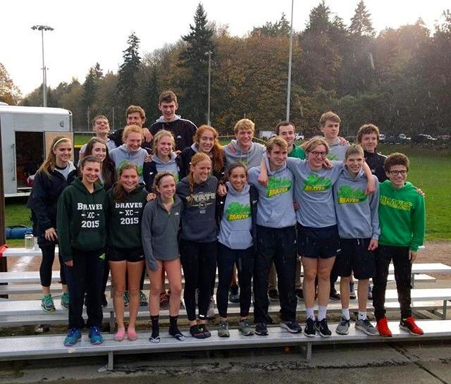 Boys and girls varsity cross country teams pose after the district meet.