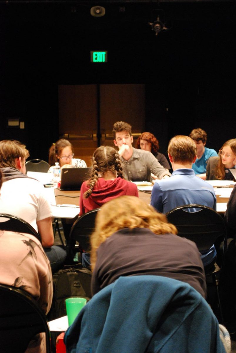 Mr. Robert Bergin, the Director of the fall play, listens carefully to his actors as they whole cast and all the crews make their way through the first read-through.