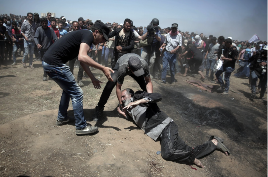 NOT BACKING DOWN : An elderly man lays fallen on the ground during the protests taking place on the border of Gaza, after the opening of the US Embassy in Jerusalem. These protests quickly became violent, leaving over 2,000 people wounded. May 14, the opening day of the embassy, is now the bloodiest day on the Gaza Strip has seen since 2014. New York Times
