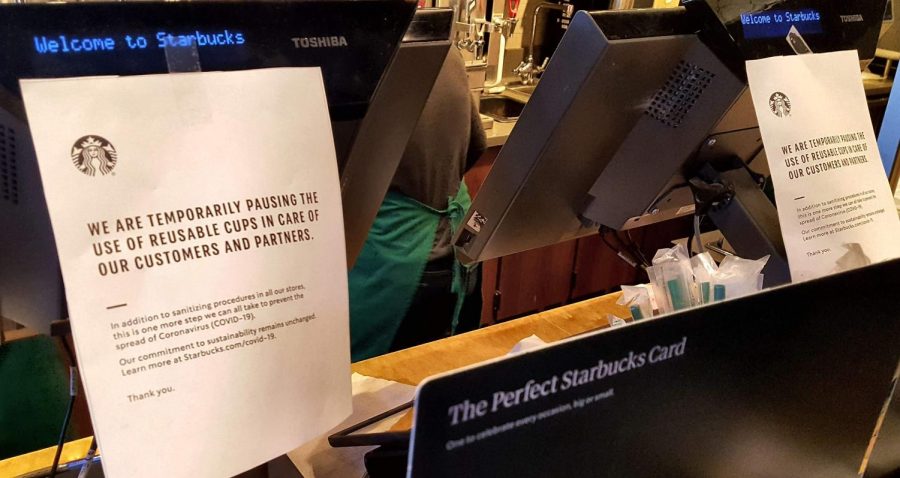 Posters+taped+to+a+register+at+a+Starbucks+in+Charlottesville%2C+Virginia+letting+customers+know+that+reusable+cups+will+not+be+used+during+the+ongoing+COVID-19+outbreak.+