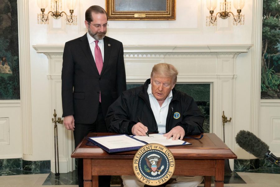 President Donald J. Trump, joined by Secretary of Health and Human Services Alex Azar, signs the congressional funding bill for coronavirus response Friday, March 6, 2020, in the Diplomatic Reception Room of the White House. 