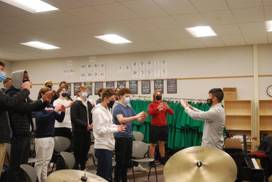 Mr. Kirk Roa leads his choir in vocal warm ups  